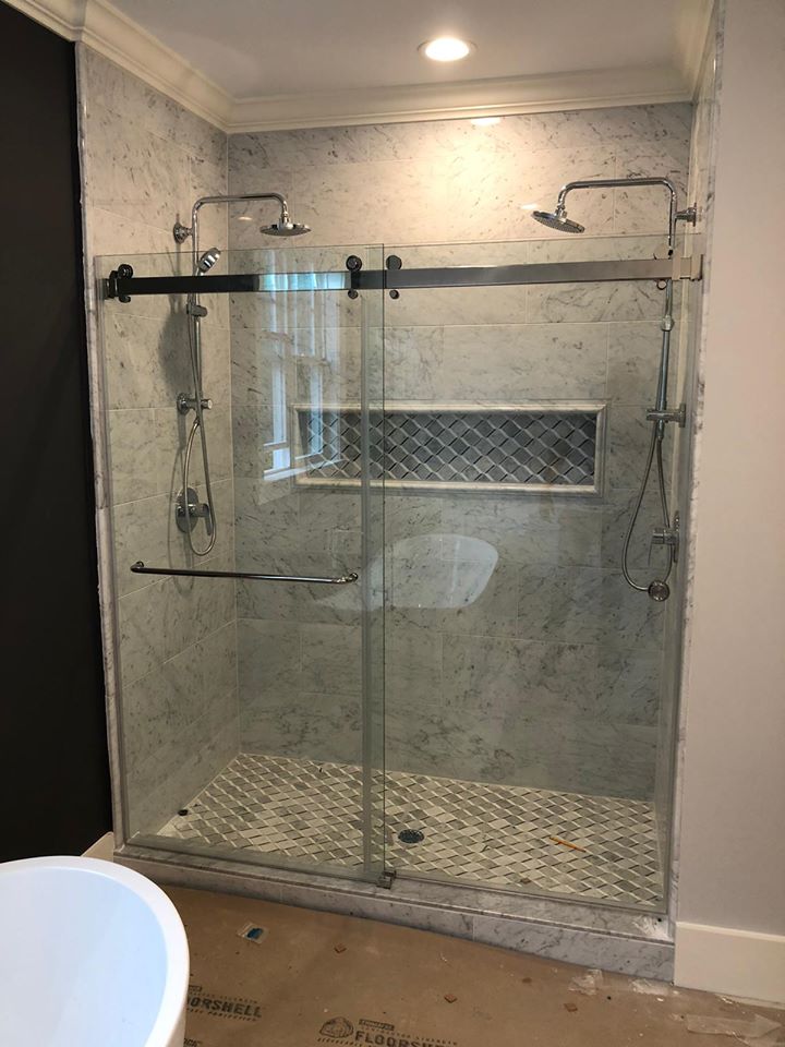 Frameless glass shower enclosures